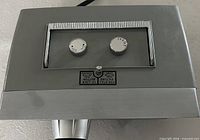 Top view showing two chrome control knobs and locking instruction plate