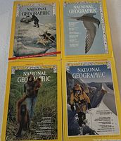 Four National Geographic magazines laid out, showing covers from mid-1970s period