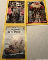 Three National Geographic magazines displayed: March 1975 (Basque cover), September 1975 (New Guinea cover), December 1976 (Viking ship cover)