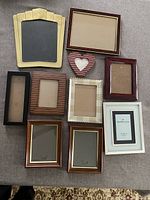 All ten assorted picture frames displayed on surface
