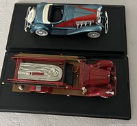Both die-cast vehicles on display bases, top view