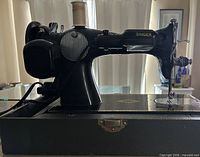 Left side view of Singer 15J sewing machine on base