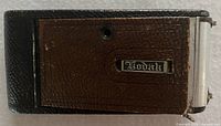 Camera closed showing brown leatherette cover with Kodak badge