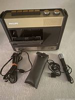 Front view of Philips 1530 cassette recorder with accessories laid out