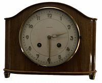 Front view showing Junghans dial, wooden case and brass bezel