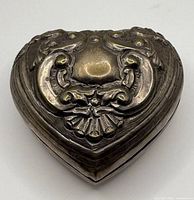 Top view of heart-shaped trinket box showing ornate embossed design
