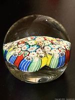 Front view of clear glass dome showing colourful millefiori pattern