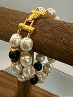 Full view of double-strand bracelet draped to show clasp and beads