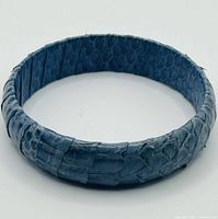 Full view of blue snakeskin bracelet showing exterior texture