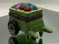 Front three-quarter view of porcelain veggie wagon trinket box