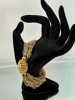 Bracelet on display hand, showing multi-strand chains and clasp