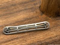 Front view of sterling silver bar brooch showing openwork design