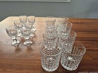 Group of 8 lowball and 6 cordial crystal glasses on table