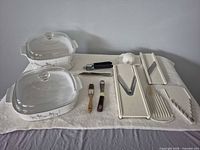 Overall lot: two CorningWare casseroles with lids, Börner mandoline components, assorted utensils