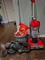Group shot showing upright vacuum, handheld vacuum, spin mop bucket and pads