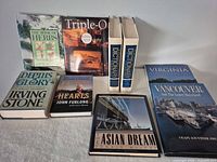 All nine hardcover books arranged face up showing titles and spines