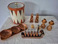 Group shot showing all items: ice bucket, condiment set, candlesticks, shakers, bar tool set