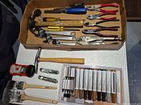 Overview of full lot showing tools, brushes, stud finder, furniture repair kit