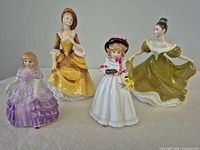 Group view of all four Royal Doulton figurines