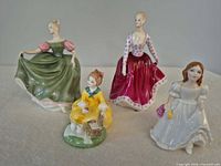 All four Royal Doulton figurines standing together