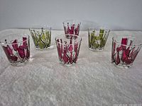 Six small tumblers, three burgundy design, three olive green design