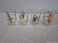 Front view of four Looney Tunes tumblers