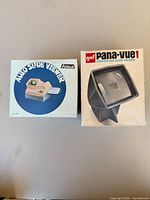 Front view of both boxed slide viewers