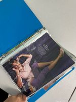 Open blue binder showing sheet protector with color Got Milk? ad inside