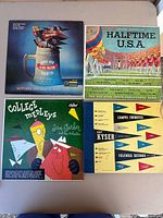 All four record sleeves laid out on table