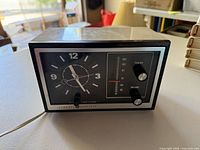 Front view showing clock face, tuning scale, knobs