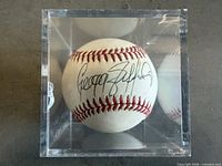 Autographed baseball in acrylic cube, autograph visible