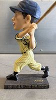 Left side view of Joe DiMaggio bobblehead showing batting pose, uniform details, base and name plaque