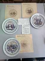 Overview showing all three plates, three story pamphlets, and certificate
