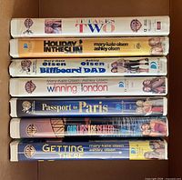 Spine view of all seven VHS tapes stacked