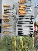 Overview of bags and grouped hand tools laid out on table