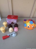 Entire lot with tin, scoops, cones, scooper, gear ball