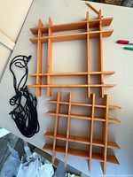 Large and small wooden lattice risers with bundled black cords