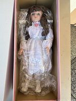 Doll in box wrapped in plastic