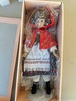 Doll in box sealed in plastic