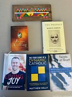 Overview of five books and wooden Last Supper plaque