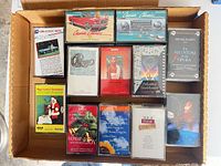 Box with assorted cassette tapes visible