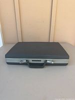 Closed Samsonite hard-shell briefcase front view