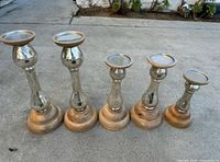 All five candle holders lined up showing design and graduated heights