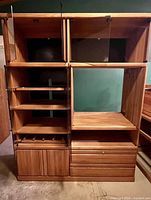 Front view with doors open showing adjustable shelves, retractable doors, drawers, lower cabinet