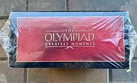 Shrink-wrapped burgundy slipcase top view with gold title