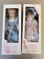 Front view of both boxed dolls showing names and series