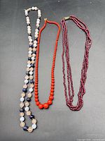 All three necklaces laid flat showing overall styles