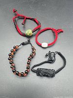 Group shot of all four bracelets arranged on surface