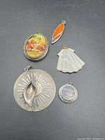 Group of five assorted pendants
