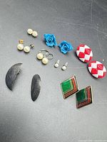 All eight pairs of earrings laid out